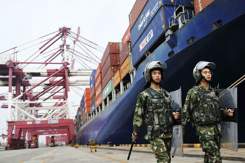 Police patrol in the fall of 2016 at the port of Qingdao in eastern China. China’s foreign minister called Wednesday for U.S.-China trade differences to be settled through dialogue and consultation. 