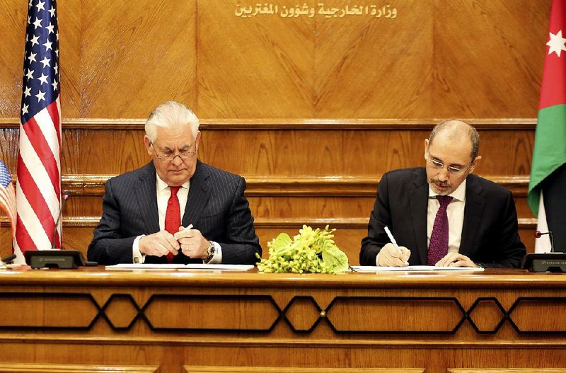 U.S. Secretary of State Rex Tillerson (left) and Jordan’s Foreign Minister Ayman al-Safadi sign U.S. aid-increase agreements Wednesday in Amman. 