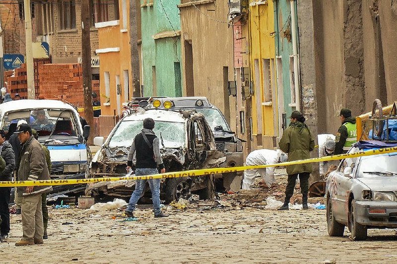 Police work Wednesday at the scene of a late Tuesday explosion in Oruro, Bolivia, that killed four people during Carnival revelry. 