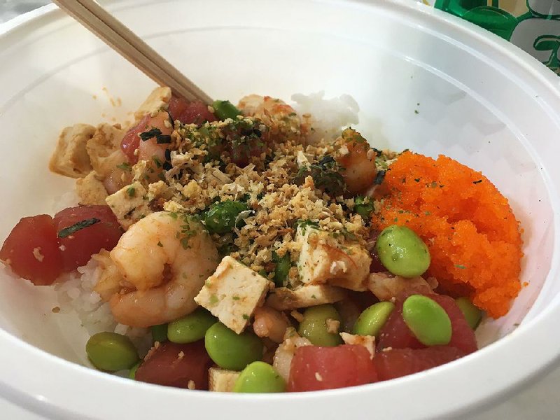 At Ohia Poke, customers choose their own assemblages for poke bowls. In this one: Shrimp, tuna and tofu over white rice, topped with edamame, masago, fried garlic and seaweed strips. 