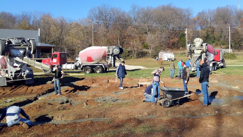 COURTESY PHOTO/Students with McDonald County High School's carpentry class work double-time to lay concrete as multiple trucks show up on-site. Aspiring carpenters apprentice under Mark Kaufman as they construct a new home from the ground up.