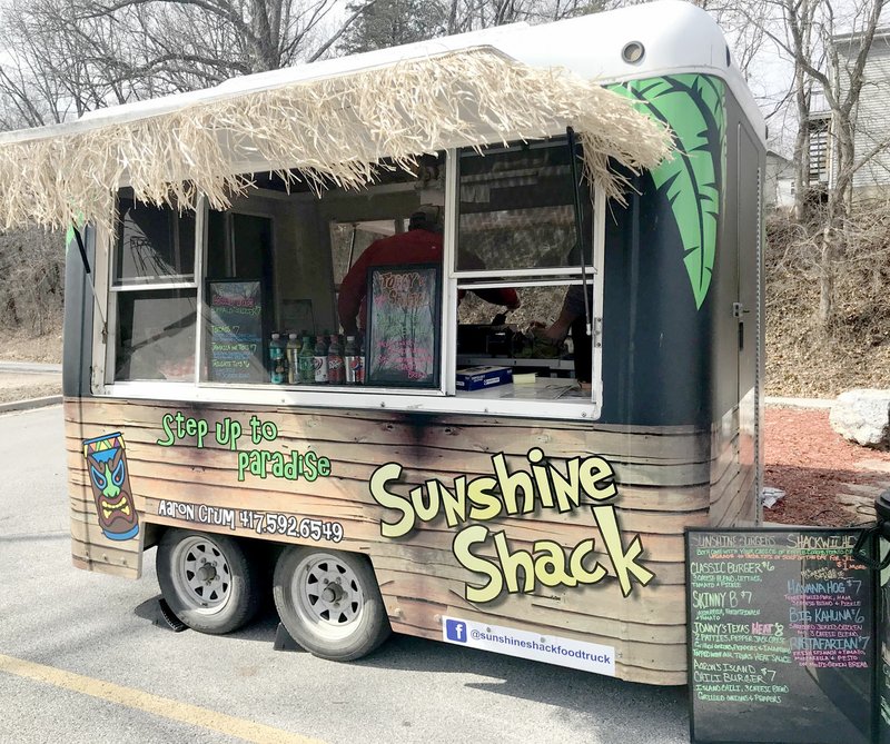 Photo by Sally Carroll Aaron Crum tries to spread a little tropical island sunshine and offer great lunch fare with The Sunshine Shack. Crum had a booming business for lunch in Pineville on a recent weekend.