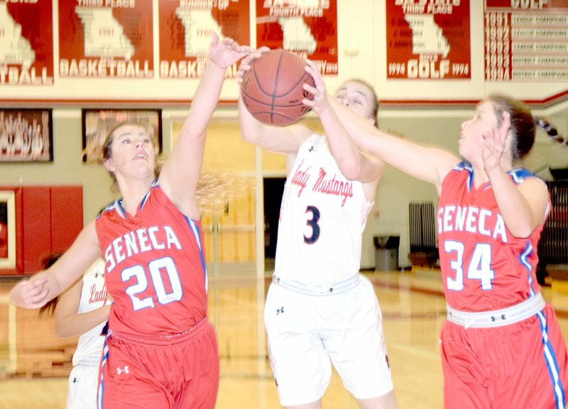 RICK PECK/SPECIAL TO MCDONALD COUNTY PRESS McDonald County's Sam Frazier gets fouled by Seneca's Chelsea Beville while Seneca's Makayla Beard goes for the ball during the Lady Indians 56-49 win on Feb. 7 at MCHS.