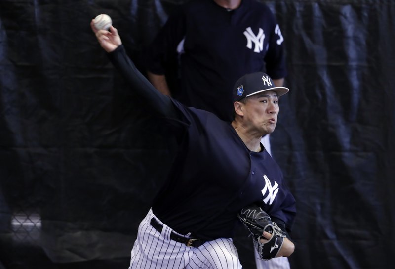 New York Yankees starting pitcher Masahiro Tanaka, of Japan, throws in the bullpen at baseball spring training camp, Wednesday, Feb. 14, 2018, in Tampa, Fla. (AP Photo/Lynne Sladky)