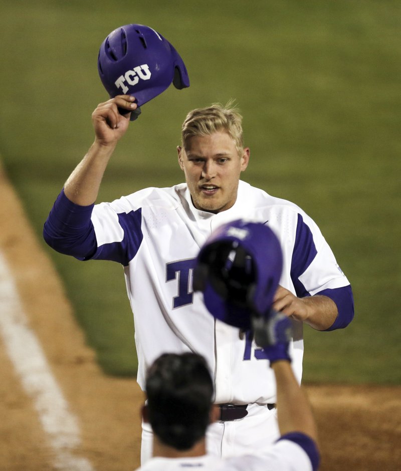 FILE - In this March 24, 2017, file photo, TCU's Luken Baker is greeted at the plate by Josh Watson after a solo home run in the eighth inning against Oklahoma State during an NCAA college baseball game in Fort Worth, Texas. The Horned Frogs head into the 2018 baseball season looking to become the first program to make five straight College World Series appearances since the NCAA went to its current tournament format in 1999.(Richard W. Rodriguez/Star-Telegram via AP, File)
