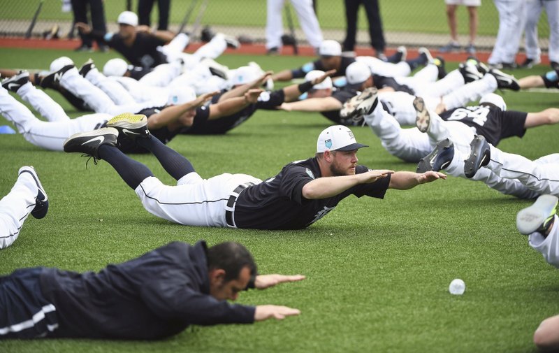 Detroit Tigers pitcher Alex Wilson does an exercise with the rest of the players during spring baseball practice, Wednesday, Feb. 14, 2018 in Lakeland, Fla. (Robin Buckson/Detroit News via AP)