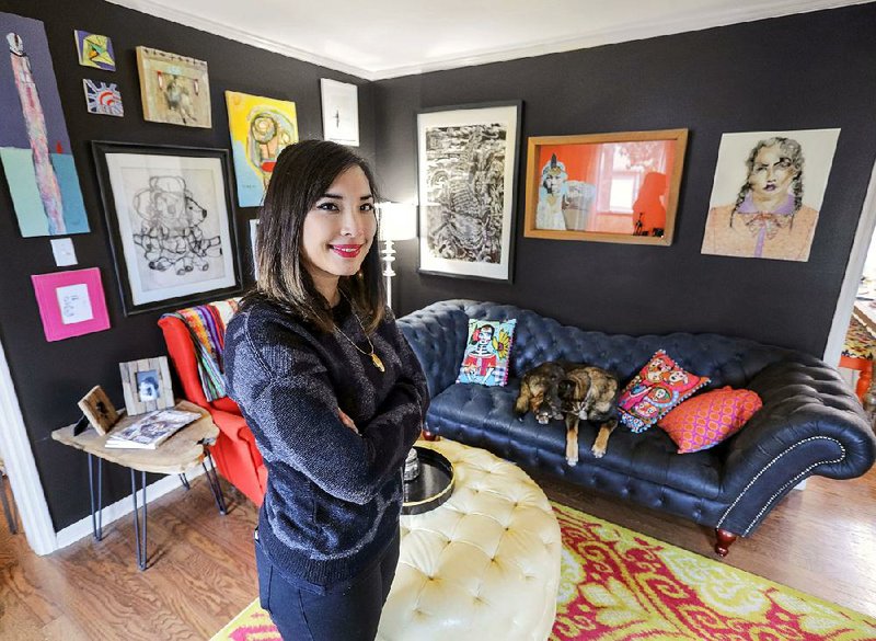 Lisa Krannichfeld Walden in her living room with the black sofa and art.