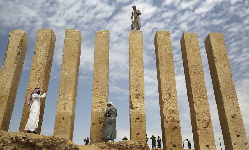 A militiaman stands atop a limestone column at the Awwam Temple, also known as the Mahram Bilqis, in Marib, Yemen. Experts fear the temple, as well as other historic and cultural wonders across Yemen beyond those acknowledged by international authorities, remain at risk as the country’s stalemated Saudi-led war against Shiite rebels continues on.