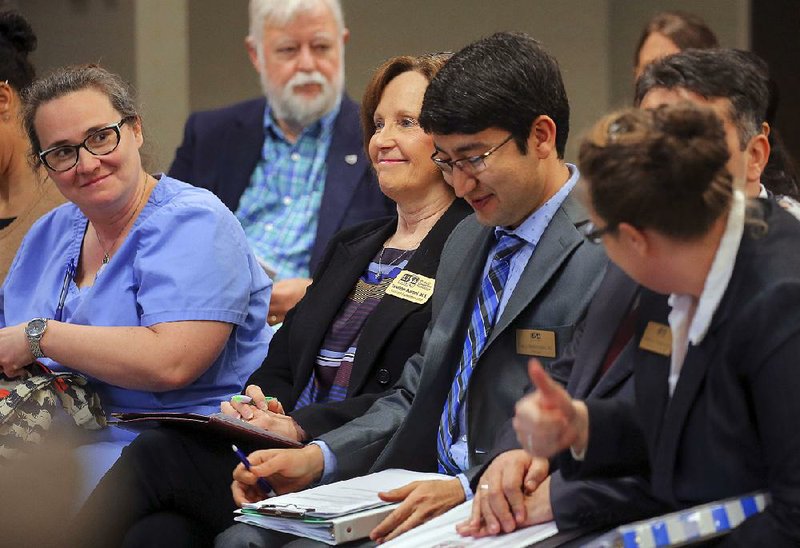 Bethany Ratermann, elementary school principal at LISA Academy-North charter school, gives a thumbs up Thursday to parent Valerie Martin (left), Assistant Superintendent Luanne Baroni and high school Principal Yagmyr Berdimyradov after the state Charter Authorizing Panel’s vote.