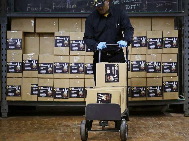A worker pushes a hand truck at the BSD Industries facility in Chicago in December. The rise in wholesale prices in January is seen underscoring signs of stronger inflation.
