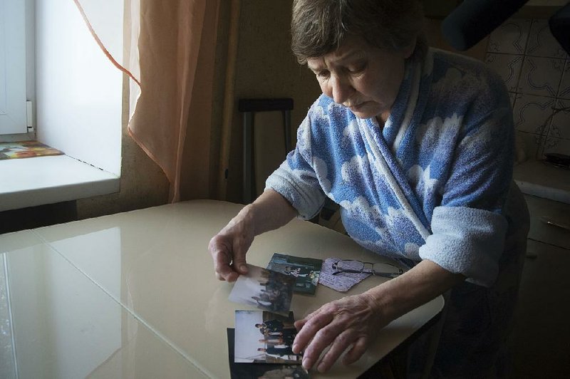 Farkhanur Gavrilova looks at photos of her son, Ruslan Gavrilov, one of seven men from the village of Kedrovoye, Russia, who are believed to have joined a private military company involved in an attack on U.S.-backed Kurdish fighters in Syria.  