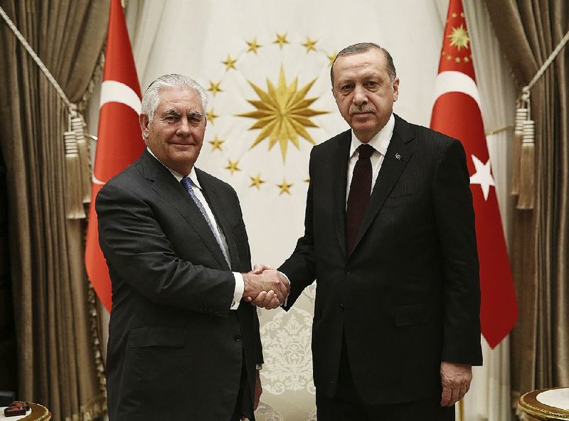 Turkish President Recep Tayyip Erdogan (right) greets U.S. Secretary of State Rex Tillerson before their talks Thursday at the presidential palace in Ankara. 