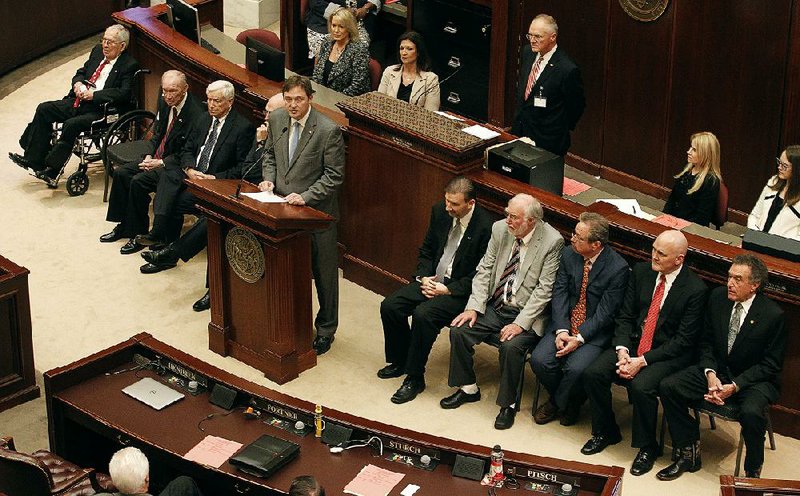 House Speaker Jeremy Gillam, surrounded by nine of his predecessors as House speaker, pays tribute to former Parliamentarian Tim Massanelli, who died Monday.