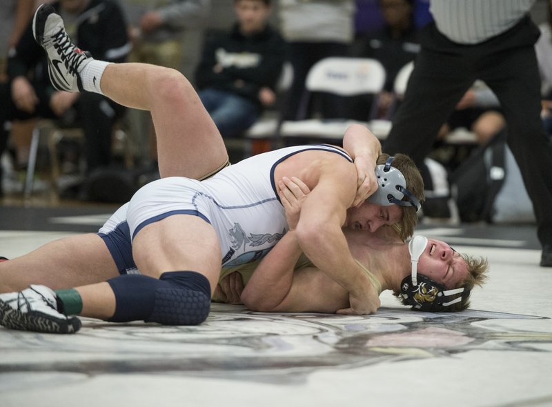 NWA Democrat-Gazette/BEN GOFF @NWABENGOFF Logan Collins (top) of Springdale Har-Ber has earned the top seed in the 195-pound weight class at this weekend's Class 6A-7A Arkansas High School State Wrestling Championships. The senior will try to help lead the Wildcats to their third state title.