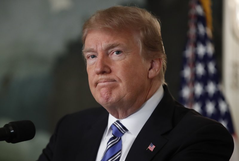 President Donald Trump pauses as he arrives to speak about the mass shooting at a South Florida High School from the White House, Thursday, Feb. 15, 2018, in Washington. (AP Photo/Carolyn Kaster)