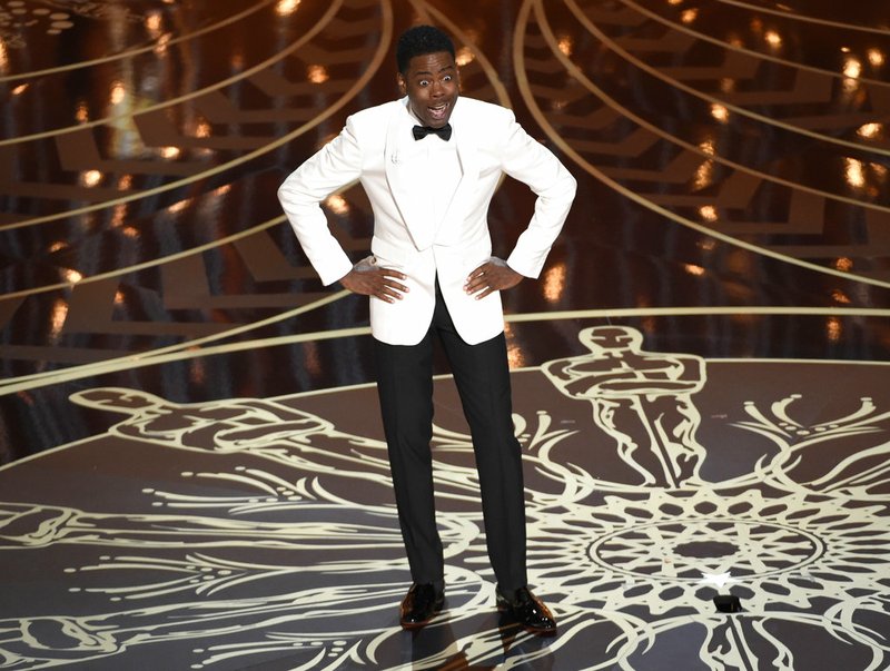 In this Feb. 28, 2016 file photo, Chris Rock hosts the Oscars in Los Angeles. Rock, hosting his second Oscar show in 2016, didn’t shy away from discussing the lack of diversity crisis roiling the industry and not letting go all night long. He called the Oscars the "White People's Choice Awards." 