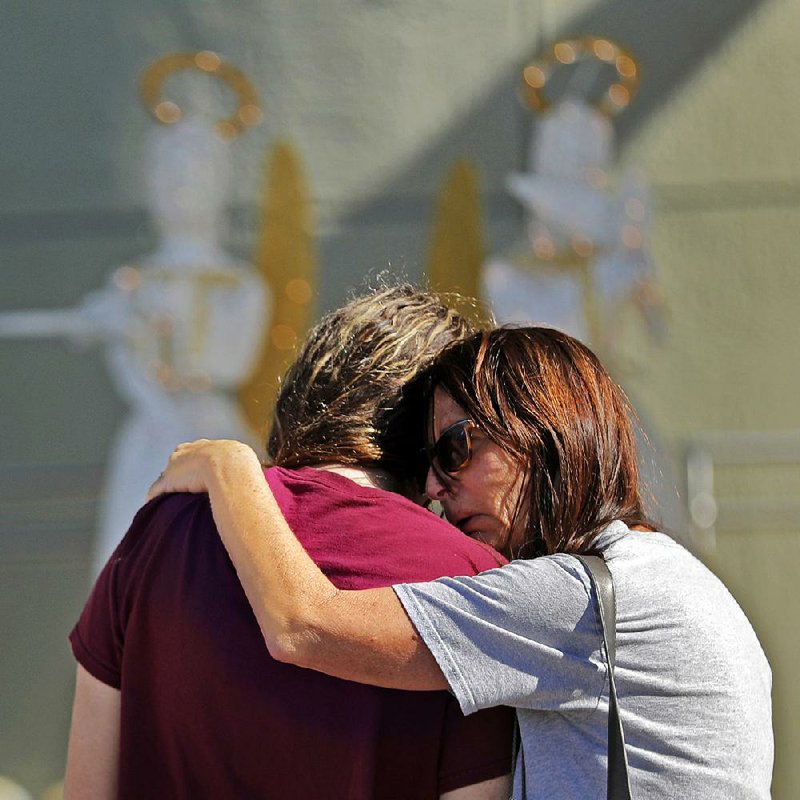 People embrace Friday at a memorial for the victims of the school shooting Wednesday in Parkland, Fla. A Jan. 5 tip to the FBI about the suspect was not forwarded to the Miami field office, officials said. 