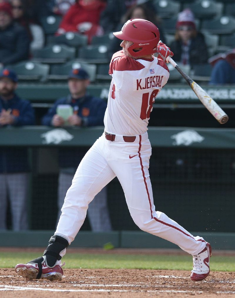 NWA Democrat-Gazette/ANDY SHUPE
Arkansas left fielder Heston Kjerstad connects with the ball for an RBI single against Bucknell Friday, Feb. 16, 2018, during the first inning at Baum Stadium in Fayetteville. Visit nwadg.com/photos to see more photos from the game.
