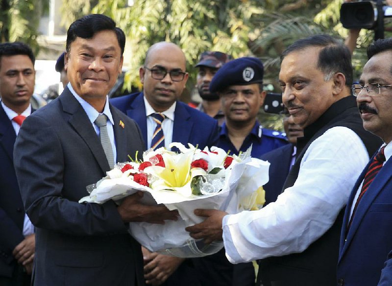 Bangladeshi Home Minister Asaduzzaman Khan (right) ceremonially welcomes his counterpart from Burma, Kyaw Swe, on Friday in Dhaka. 
