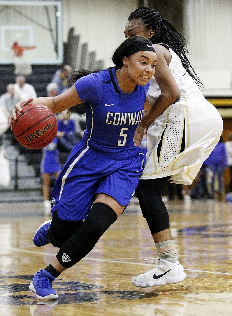 Conway’s Myia Yelder (5) drives to the basket past Little Rock Central’s Ariyanna Hall during the third quarter of Conway’s 59-54 victory Friday in Little Rock. 