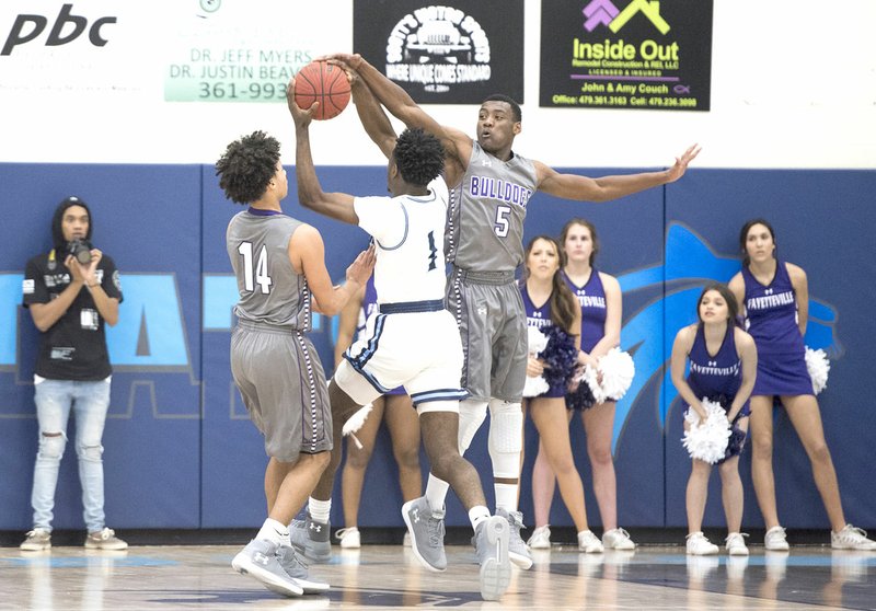 NWA Democrat-Gazette/CHARLIE KAIJO Fayetteville forward Darius Bowers (5) blocks a shot by Springdale Har-Ber's Austin Garrett (1) on Friday in Springdale.