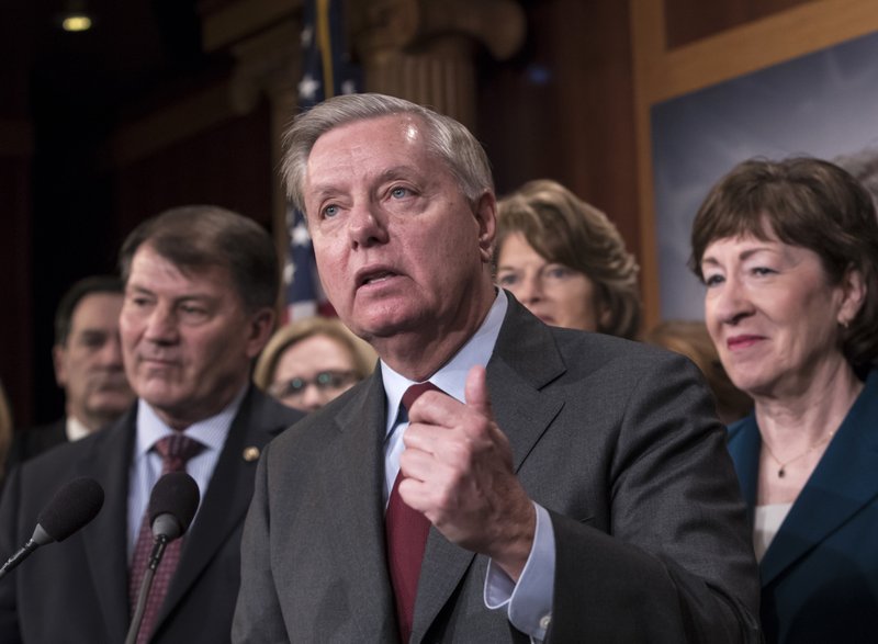 Sen. Lindsey Graham, R-S.C., flanked by, Sen. Mike Rounds, R-S.D., left, and Sen. Susan Collins, R-Maine, discuss the bipartisan immigration deal they reached during a news conference at the Capitol in Washington, Thursday, Feb. 15, 2018.  (AP Photo/J. Scott Applewhite)