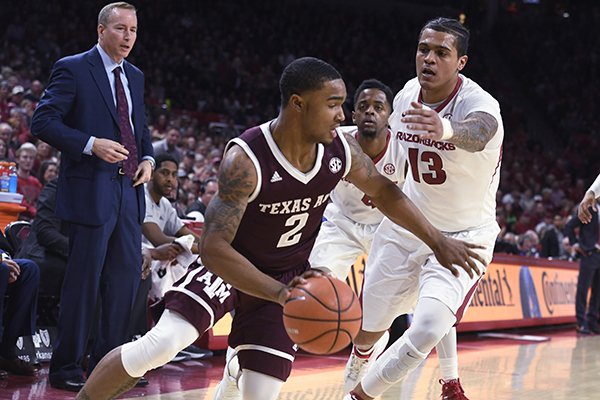 Texas A&M guard TJ Starks tries to get past Arkansas defender Dustin Thomas during the first half of an NCAA college basketball game Saturday, Feb. 17, 2018, in Fayetteville, Ark. (AP Photo/Michael Woods)

