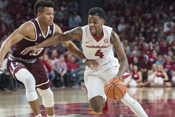 Daryl Macon of Arkansas drives to the lane as Admon Gilder of Texas A&M guards in the second half Saturday, Feb. 17, 2018, during the game at Bud Walton Arena in Fayetteville. 