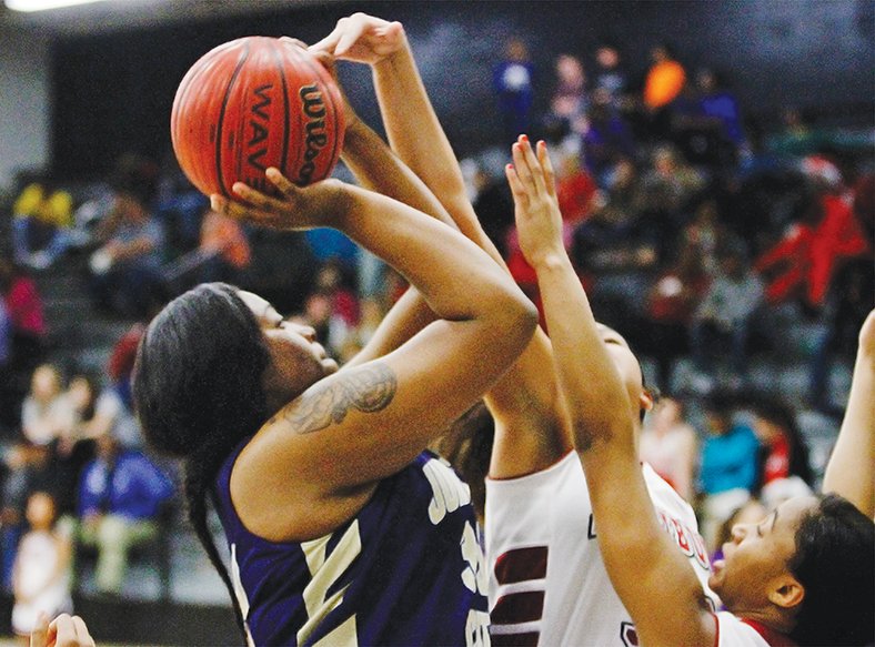 Terrance Armstard/News-Times Junction City's Jada Archie (33), left, shoots above Fordyce's Alyssa Brown (33) and Lamya Bulliner (24) during first-half action of the championship game of the 8-3A District Tournament on Friday night.