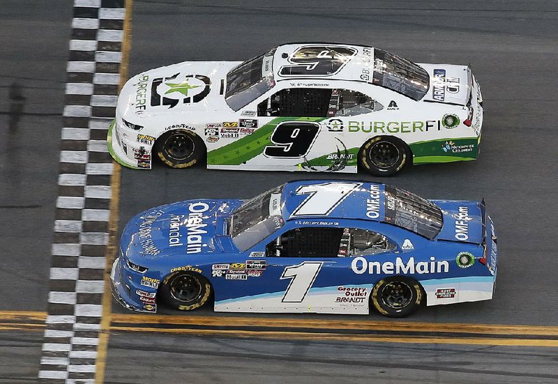 Tyler Reddick (9) edges Elliott Sadler at the finish line to win Saturday’s NASCAR Xfinity Series race at Daytona International Speedway. The margin of victory was officially listed at 0.000 seconds, making it NASCAR’s closest finish ever. 