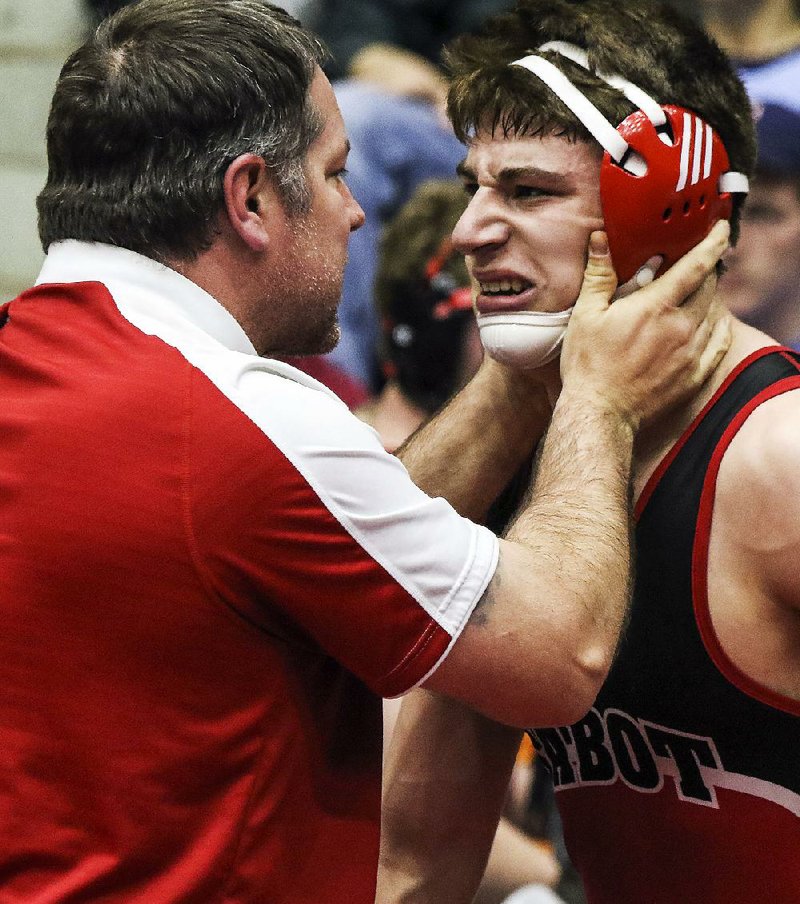Cabot Coach Justin Turner tries to cool down C.J. Long after things got a little heated during the Class 6A-7A 195 pound championship match against Logan Collins of Springdale Har-Ber at the state high school wrestling championships at the Jack Stephens Center in Little Rock on Saturday. Long executed an escape with one second remaining to win the individual title. 
