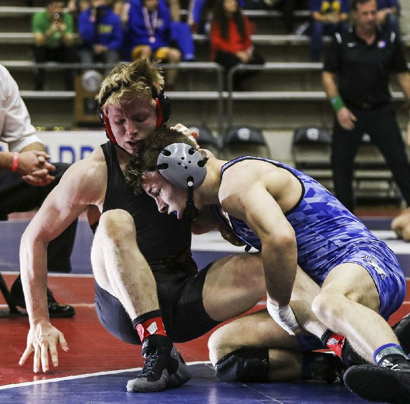 Jake Turner of Rogers (right) defeated Logan Sloss of Russellville 12-6 to win the 145-pound weight class at the Class 6A/7A state wrestling championships at the Jack Stephens Center in Little Rock on Saturday. 