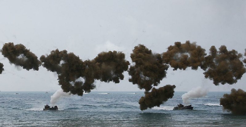 South Korean amphibious assault vehicles fire smoke screens Saturday while taking part in a U.S.-Thai military exercise on Hat Yao beach in Thailand’s Chonburi province.