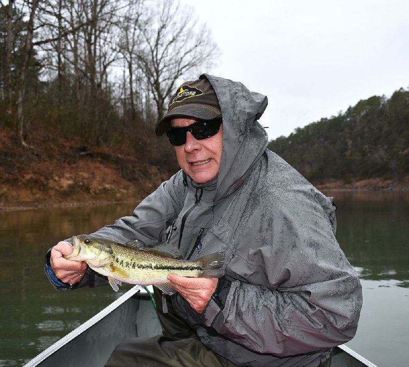 Rusty Pruitt admires one of the three spotted bass he caught Tuesday on the Ouachita River. 