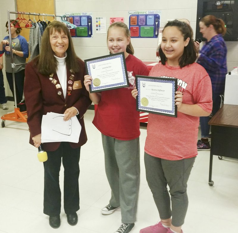 Courtesy photo Fayetteville-Springdale Elks Lodge held an Americanism essay contest among six school districts in Northwest Arkansas, and there were two fifth-grade winners from Ledbetter Middle School in Farmington. Samantha Brye (center) took home first place and received a certificate and $75. Roxanna Huffmaster placed third and received a certificate plus $25. Lodge officer Marge Guist made the presentations in front of an assembly of fifth-graders. Both essays will go on to state competition.