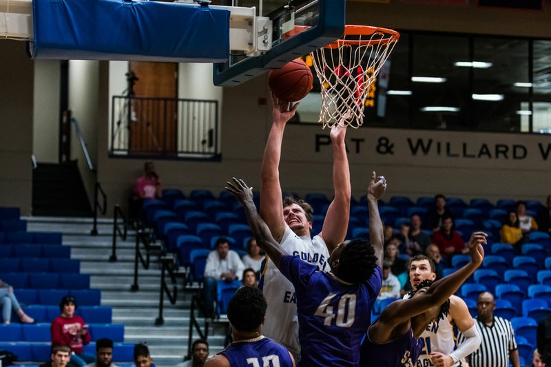 Courtesy of JBU Sports Information John Brown University's Mateo Habazin works for a shot around a crowd of Southwestern Assemblies of God defender during the Golden Eagles' 77-71 loss at Bill George Arena on Thursday.