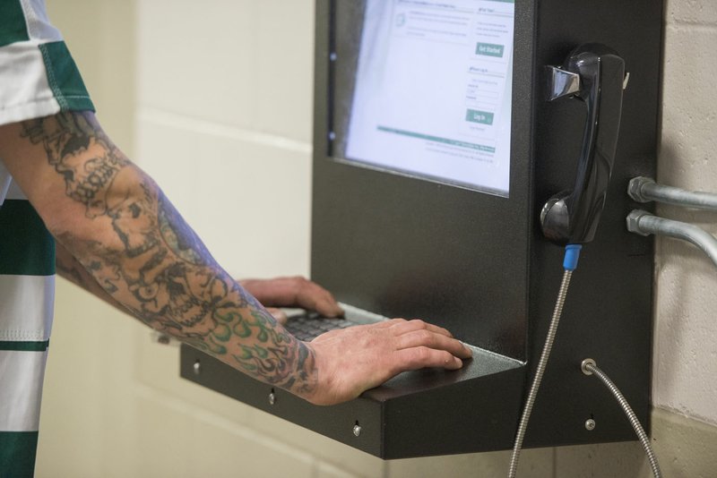 An inmate uses an email kiosk at the Benton County Jail in Bentonville. The inmates no longer receive mail from family and friends at the jail and it cut out one way contraband could get into the jail, according to Sheriff's Office officials.