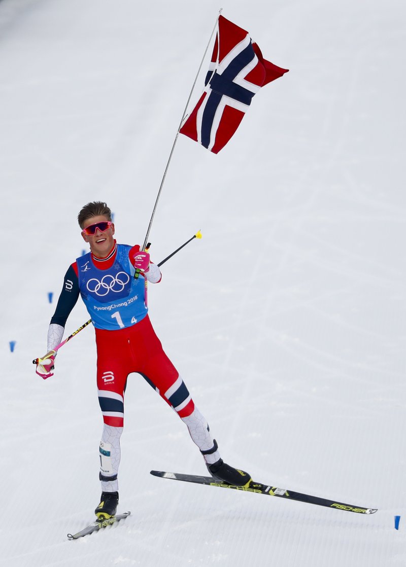 Johannes Hoesflot Klaebo, of Norway, celebrates after winning the the gold medal in the men's 4 x 10km relay cross-country skiing competition at the 2018 Winter Olympics in Pyeongchang, South Korea, Sunday, Feb. 18, 2018. 