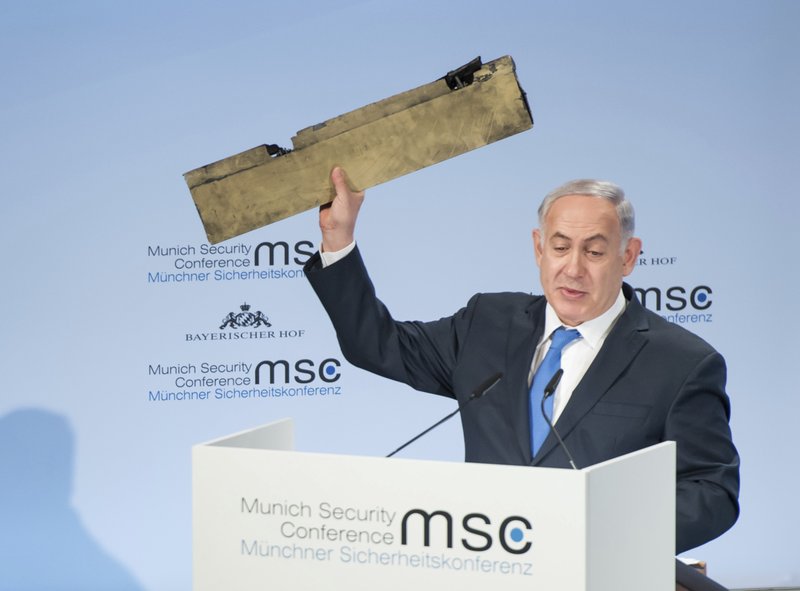 In this photo released by Lennart Preiss/MSC 2018, Israeli Prime Minister Benjamin Netanyahu, holds a part of a downed drone during his speech at the Munich Security Conference, MSC, in Munich , Germany, Sunday, Feb. 18, 2018. 