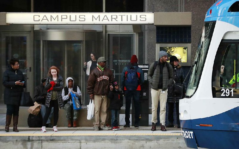 Passengers wait for the QLINE transit train in Detroit, one of the nation’s cities highlighting it racial diversity in a bid to lure tech companies and high-paying jobs.