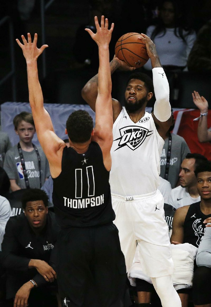 Team LeBron’s Paul George (right) of the Oklahoma City Thunder shoots as Team Stephen’s Klay Thompson of
the Golden State Warriors defends during the first half of the NBA All-Star Game on Sunday in Los Angeles. George scored 16 points as Team LeBron won 148-145.