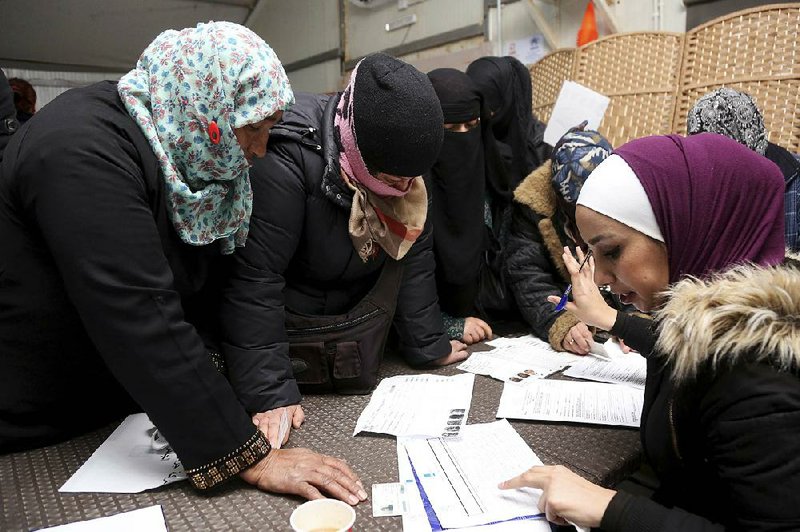 Syrian refugees in Jordan register at the Azraq refugee camp job center for employment Sunday.