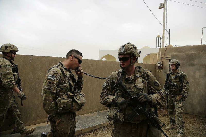 U.S. troops coordinate with Iraqi counterparts to launch airstrikes and artillery against the Islamic State from  the town of Qaim, Iraq, in January.