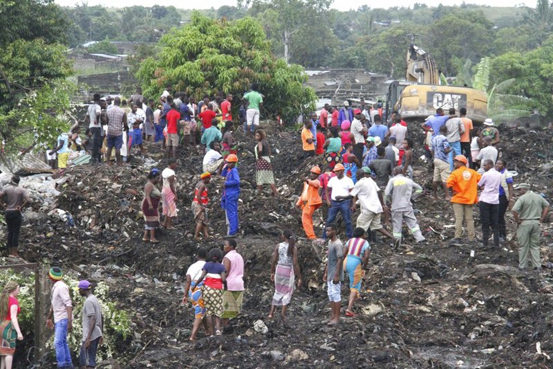 Rescuers search for survivors at the collapse of a garbage mound in Maputo, Mozambique, Monday, Feb. 19, 2018. Mozambican media say at least 17 people died when heavy rains triggered the partial collapse of the mound garbage. 