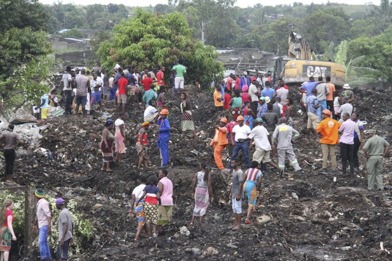 Rescuers search for survivors at the collapse of a garbage mound in Maputo, Mozambique, Monday, Feb. 19, 2018. Mozambican media say at least 17 people died when heavy rains triggered the partial collapse of the mound garbage. (AP Photo/Ferhat Momade)

