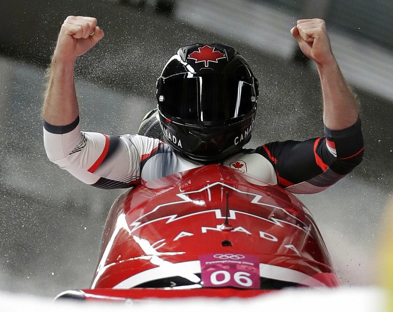 Driver Justin Kripps and Alexander Kopacz of Canada celebrate as they cross the finish area after tying for the gold with Germany during the two-man bobsled final at the 2018 Winter Olympics in Pyeongchang, South Korea, Monday, Feb. 19, 2018. 