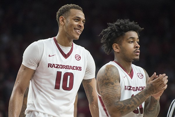 Daniel Gafford (10) and Anton Beard of Arkansas react during a timeout in the second half against Texas A&M Saturday, Feb. 17, 2018, during the game at Bud Walton Arena in Fayetteville.