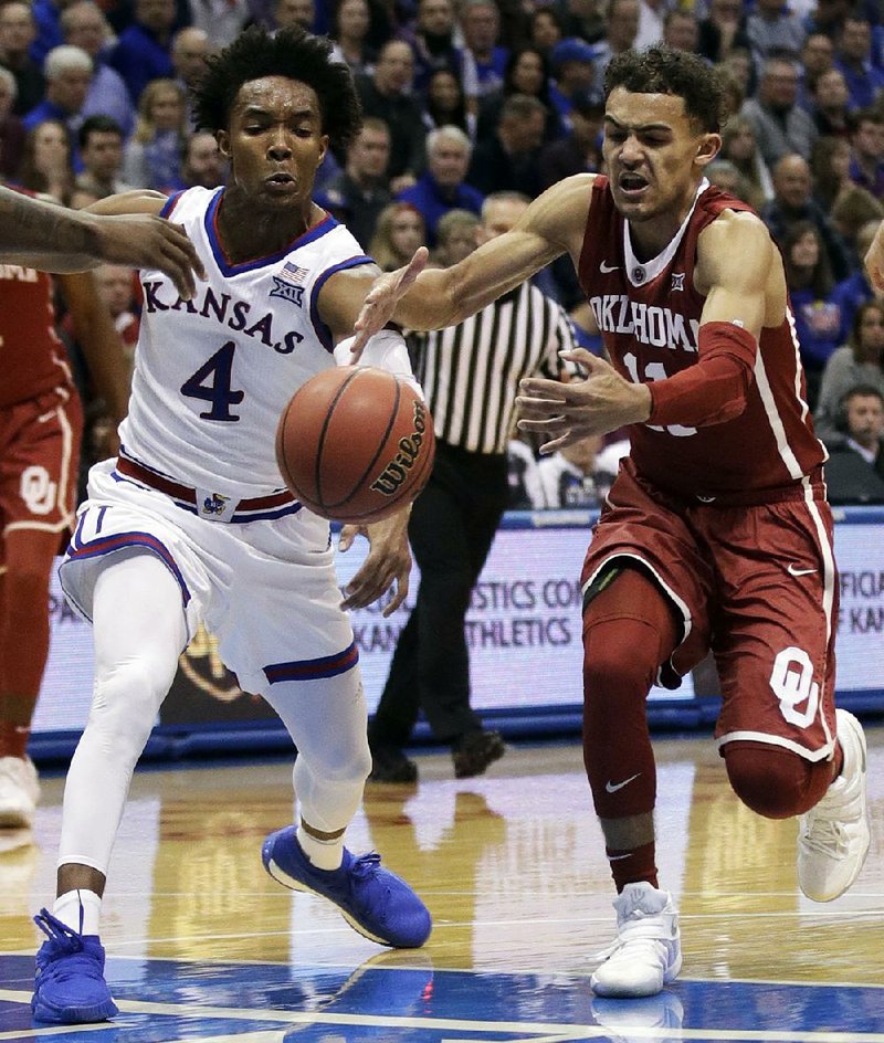 Kansas guard Devonte’ Graham (4) scored 23 points and had 7 assists while Oklahoma guard Trae Young had 11 points and 9 assists in the Jayhawks’ 104-74 victory over the Sooners on Monday night in Lawrence, Kan.
