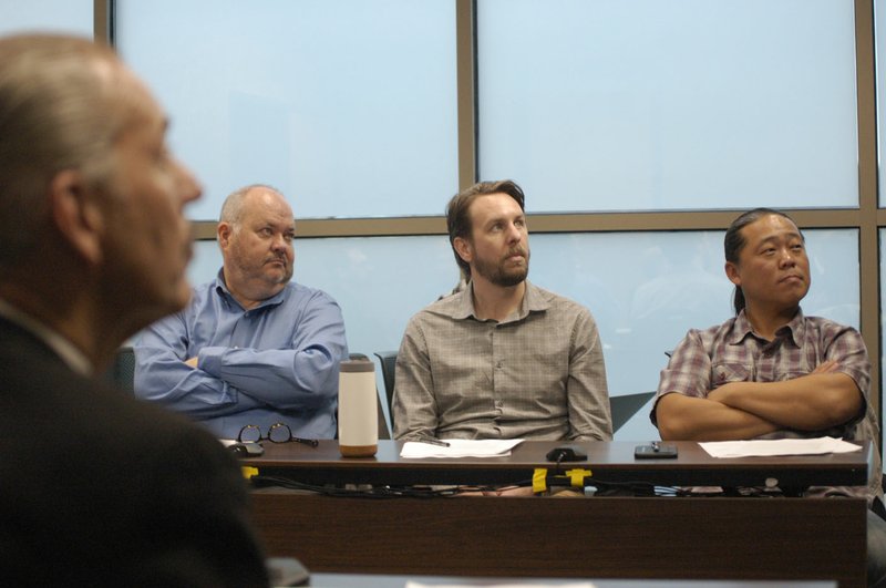 NWA Democrat-Gazette/STACY RYBURN Robert Rhoads (foreground), Todd Martin (left), Matt Behrend and Ching Mong, all with the Fayetteville Advertising and Promotion Commission, pay attention during a marketing report at the commission's meeting Monday.