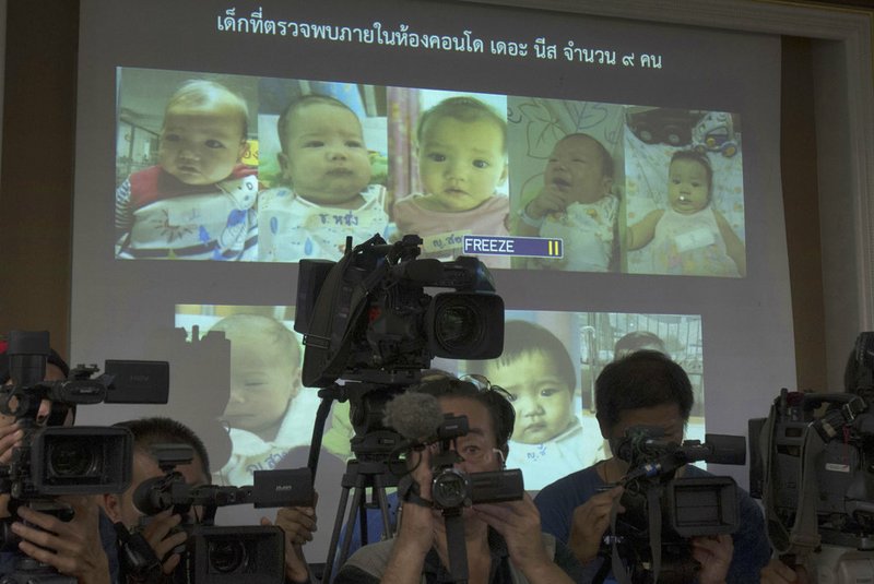 In this Aug. 12, 2014, file photo, the media attend a press briefing where Thai police display projected pictures of surrogate babies born to a Japanese man who is at the center of a surrogacy scandal during a press conference at the police headquarters in Chonburi, Thailand. Bangkok's Central Juvenile and Family Court on Tuesday gave Mitsutoki Shigeta sole legal custody of the children he fathered using Thai surrogate mothers, ruling that he's financially stable and showed his plans to care for them. 